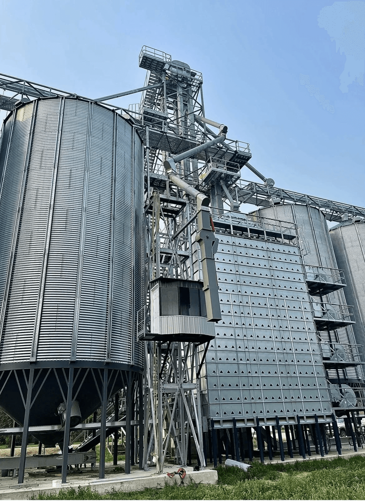 Grain dryer and elevator leg with support structure and spouting